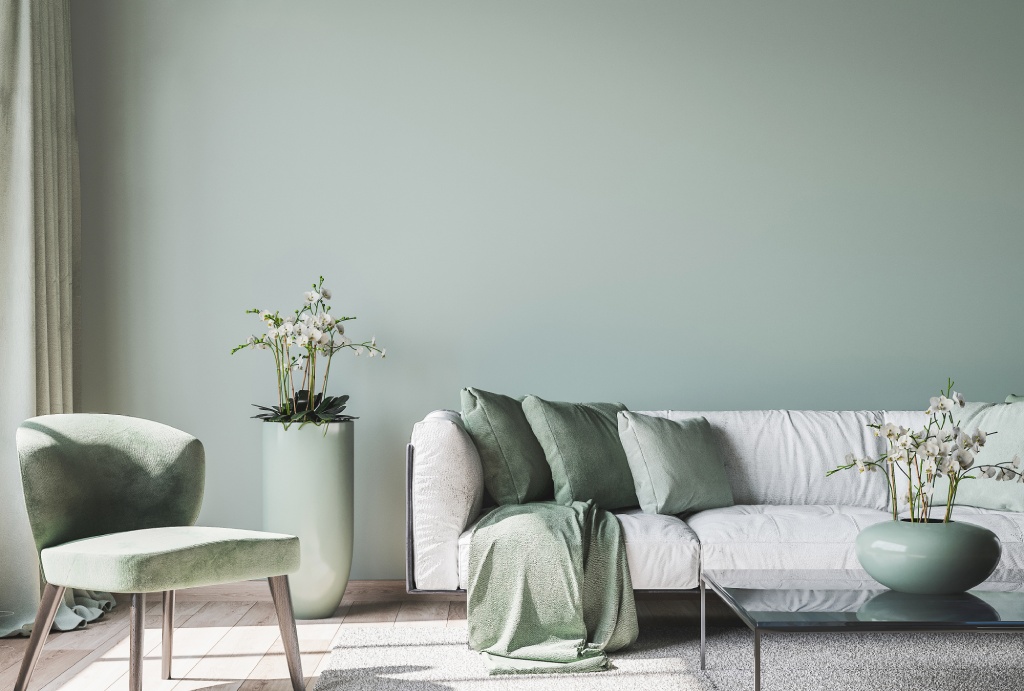Modern Minimalist Living Room with Sage Green Accent Wall White Sofa and Velvet Armchair.jpg